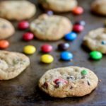 Sometimes you need to feel like a kid. That's why you need colorful chocolate covered candies in your cookies. Made with a little dose of whole grains and a little less sugar than other cookies, these Rainbow Chocolate Chip Cookies make the perfect sweet treat. @cookinRD | sarahaasrdn.com