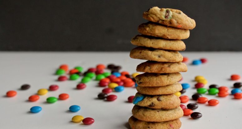 Sometimes you need to feel like a kid. That's why you need colorful chocolate covered candies in your cookies. Made with a little dose of whole grains and a little less sugar than other cookies, these Rainbow Chocolate Chip Cookies make the perfect sweet treat. @cookinRD | sarahaasrdn.com