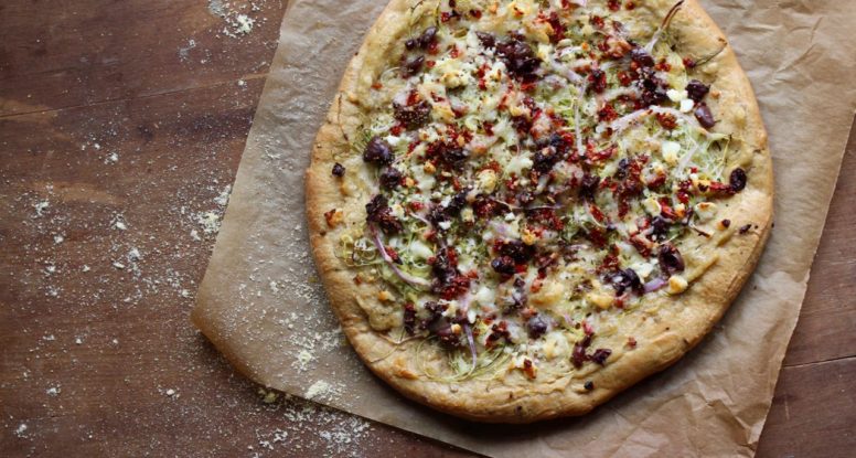 Looking for a fun, new way to enjoy pizza? Try this Mediterranean Pizza which starts with a layer of hummus and gets topped with tons of fresh veggies, feta cheese and olives! @cookinRD | sarahaasrdn.com