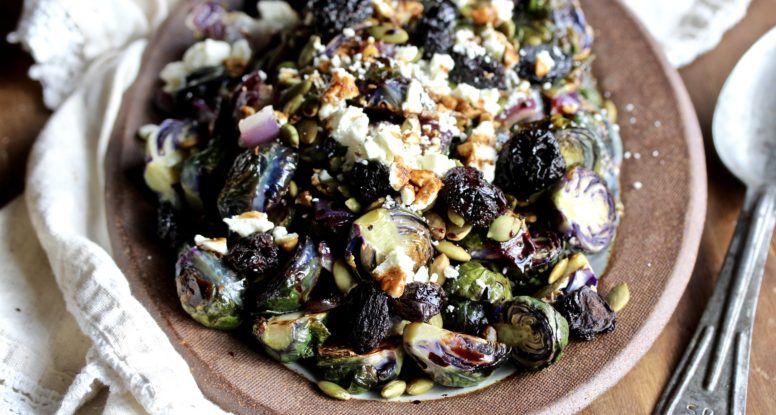 The perfect side dish to any holiday meal! These Roasted Brussels Sprouts are festively topped with dried cherries, toasted pumpkin seeds and balsamic reduction! @cookinRD | sarahaasrdn.com